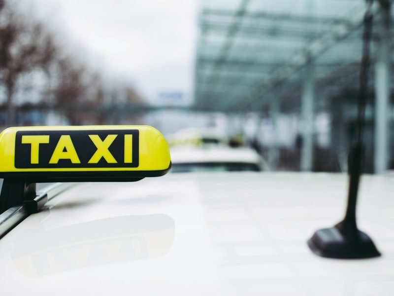 yellow and black taxi sign